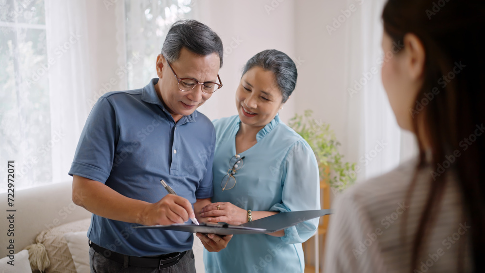 custom made wallpaper toronto digitalfemale realtor make property offer for sale to elderly spouses old customers contract on table,buy new home,take bank loan or medical health insurance concept.Financial advisor,realtor agent,insurance