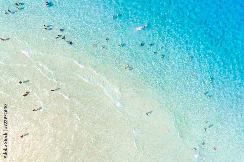 Aerial view on beach and people. Vacation and adventure. Europe, Mediterranean Sea. Top view from drone at beach and azure sea. View on the coast from drone.