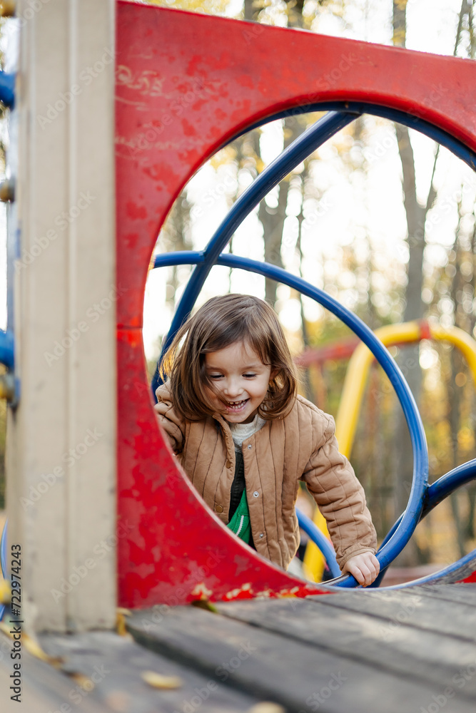 a playful and contented child plays on the old municipal playground a playful and contented child plays on the old municipal playground