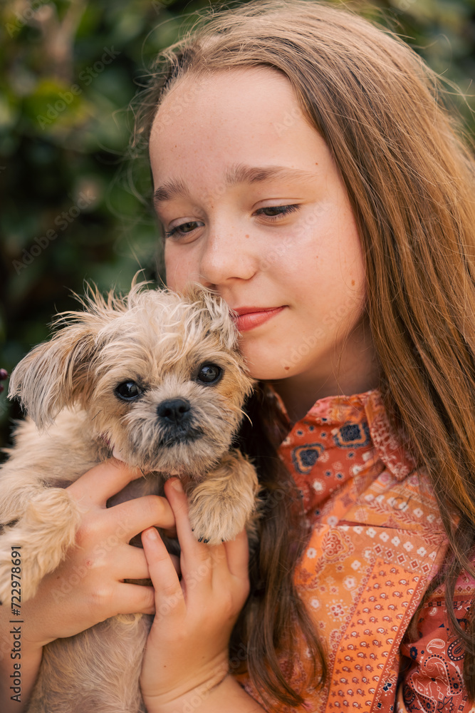 Pre-teen girl snuggling little dog Pre-teen girl snuggling little dog