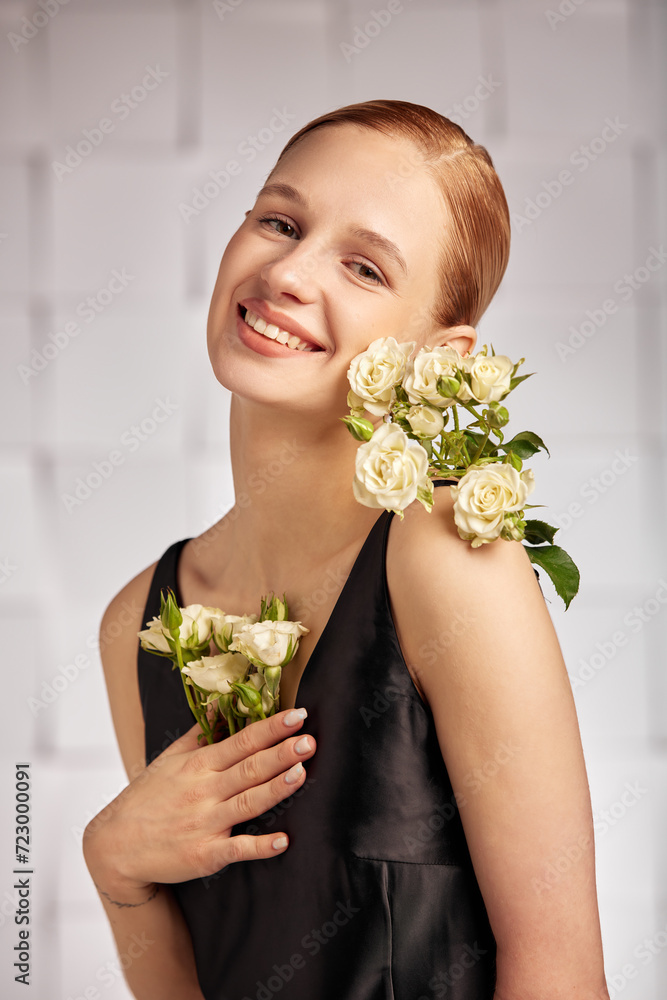 Beautiful young with special needs woman with flowers in her hand, smiles cheerfully, holding a flower in her hands in a black dress. Diversity Beautiful young with special needs woman with flowers in her hand, smiles cheerfully, holding a flower in her hands in a black dress. Diversity