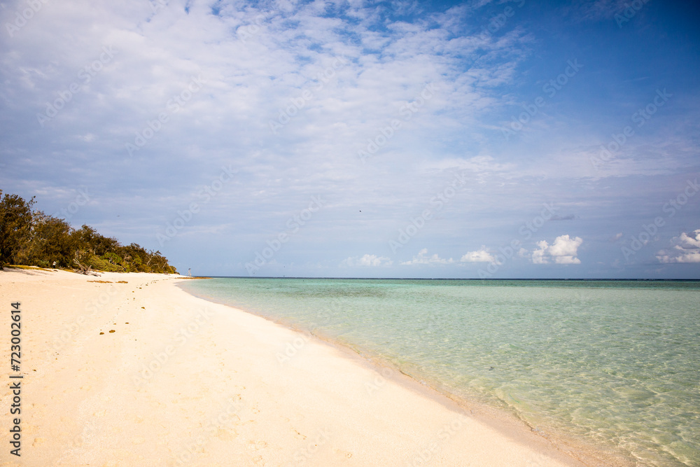 sunny day at a sandy beach on the shore of a tropical island sunny day at a sandy beach on the shore of a tropical island