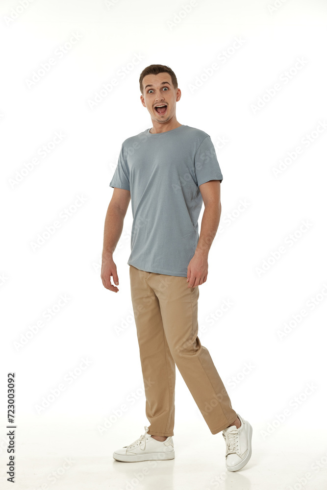 surprised guy looking at camera on white studio background