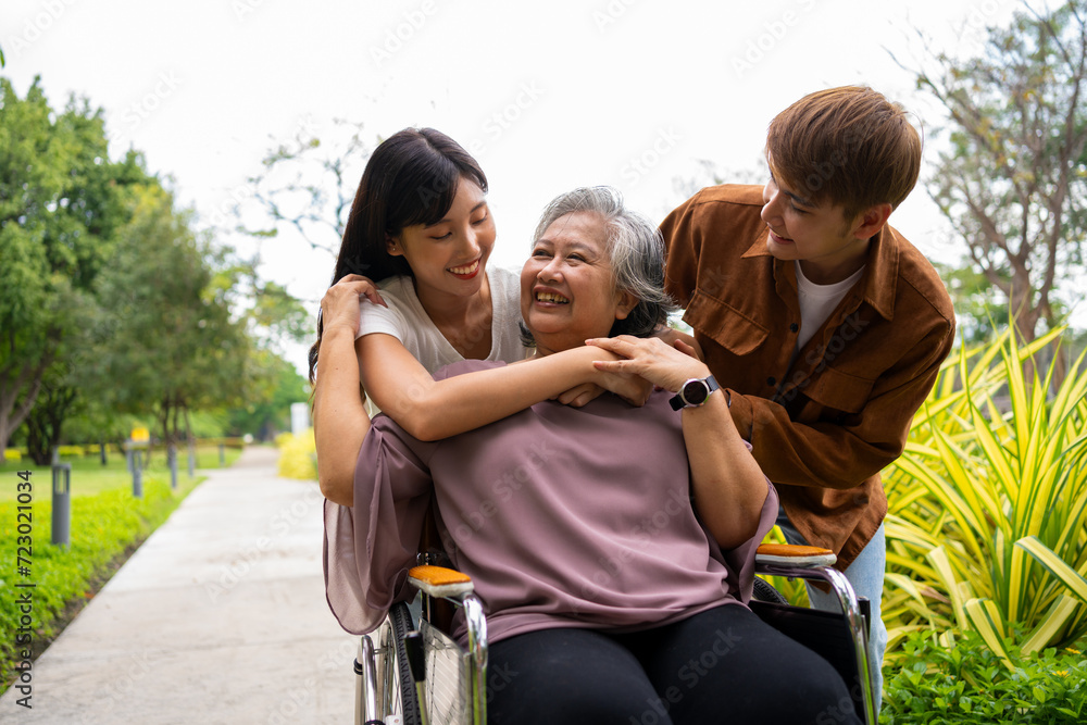 Asian careful caregiver or nurse taking care of the patient in a wheelchair. Concept of a happy retirement with care from a caregiver and Savings and senior health insurance, a Happy Family Asian careful caregiver or nurse taking care of the patient in a wheelchair. Concept of a happy retirement with care from a caregiver and Savings and senior health insurance, a Happy Family
