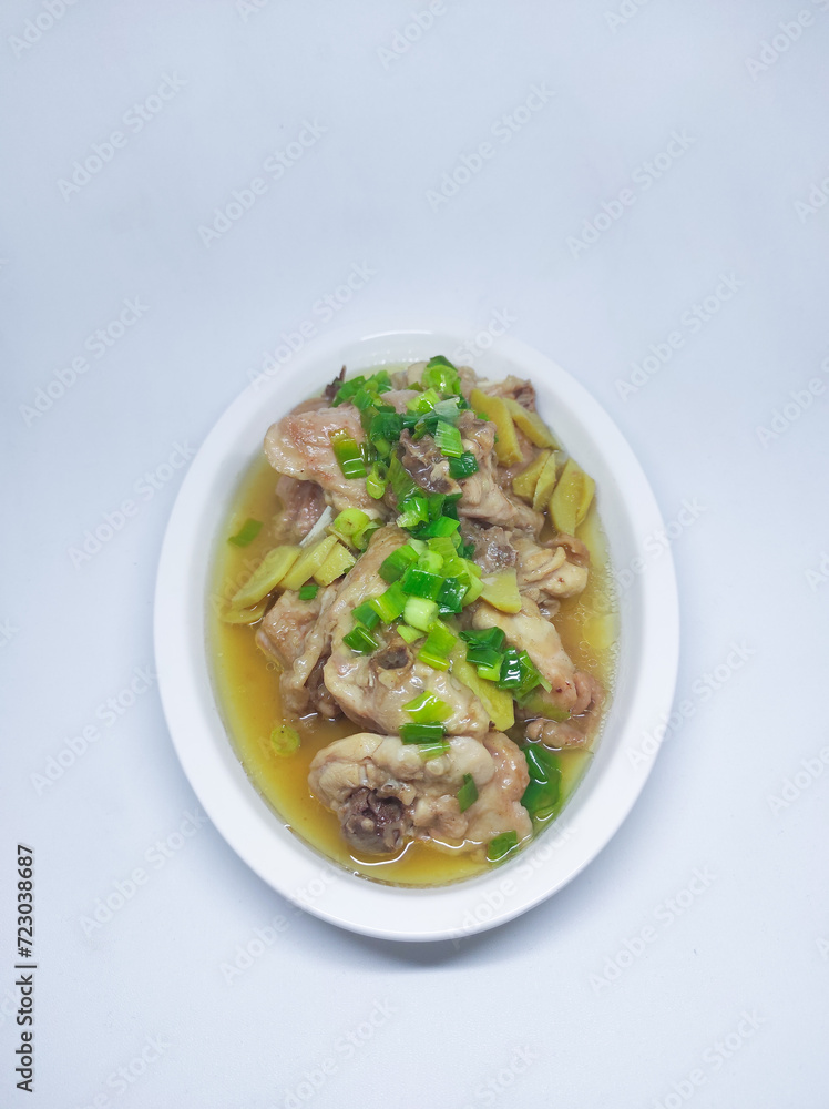 Steamed chicken meat with ginger served on plate isolated on white background Steamed chicken meat with ginger served on plate isolated on white background