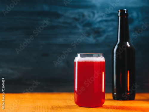 Craft sour ale on a wooden table. A glass of wine. Copy space photo