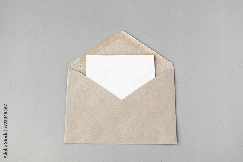 a white sheet in a beige envelope on a light background. free space for text a white sheet in a beige envelope on a light background. free space for text
