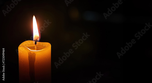 Lighted candle isolated on black