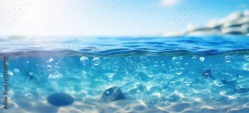The photograph showcases a vibrant blue ocean with numerous bubbles gracefully floating on the waters surface.