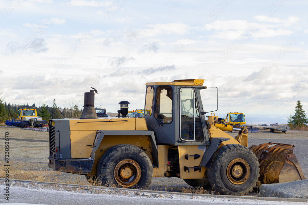 A large orange tractor for removing snow from the road. Snow clearing and clearing roads in the city in winter. Snow removal excavator after snowfalls and blizzards
