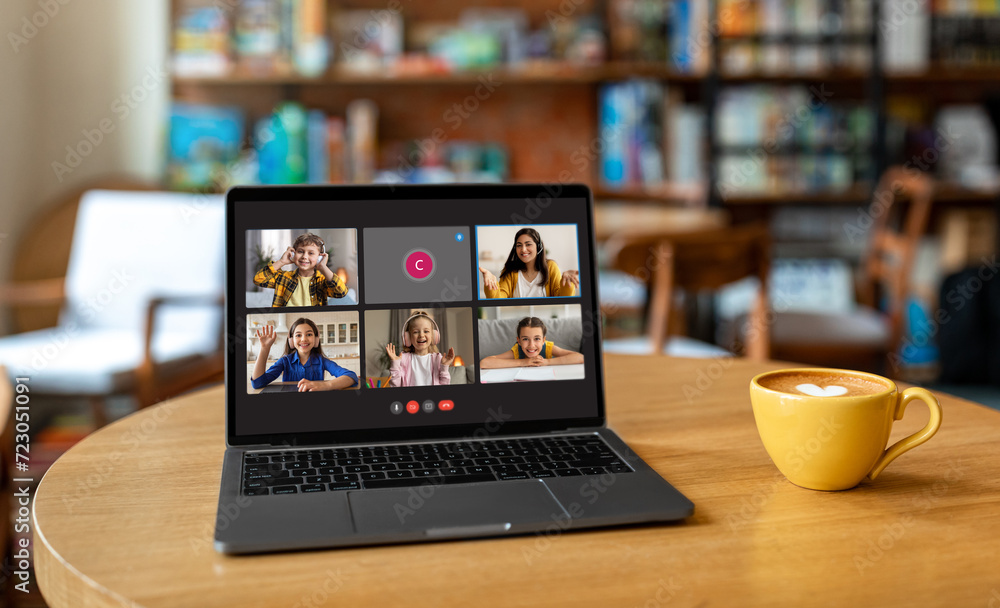 Laptop with video call online class screen on cafe table Laptop with video call online class screen on cafe table