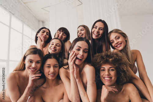 Photo of ten beautiful sisterhood touching face skin applying lotions in lingerie isolated at white studio background photo