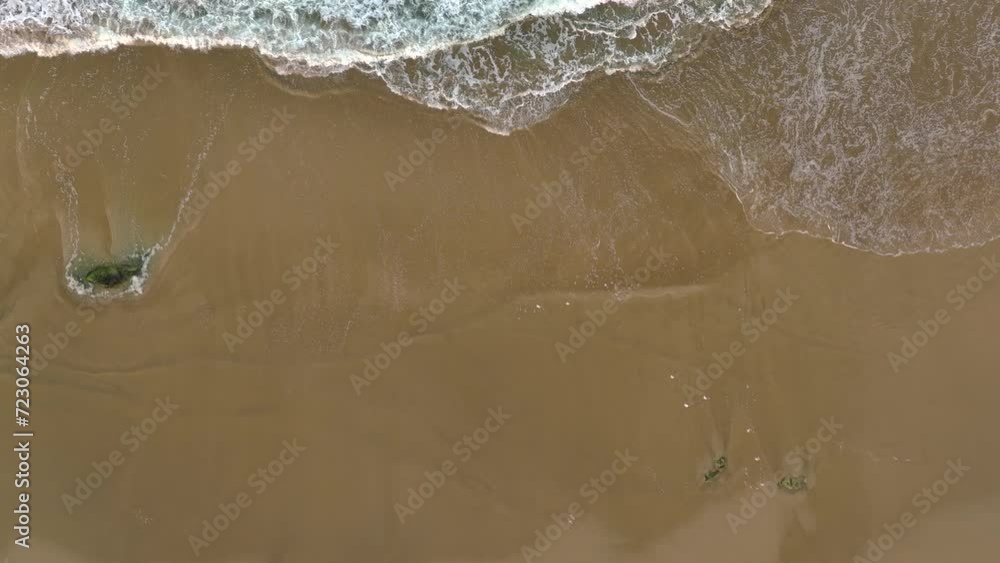 Bird's Eye View Of Sandy Beach With Foamy Ocean Waves Splashing On Shore - Slow Motion Bird's Eye View Of Sandy Beach With Foamy Ocean Waves Splashing On Shore - Slow Motion