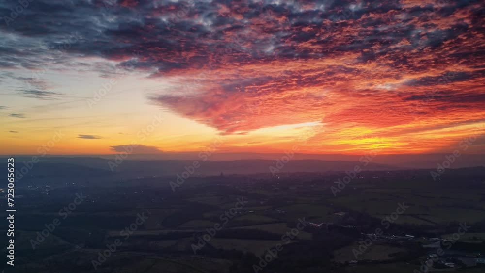 Aerial video showcases a UK summer evening, featuring a warm sunset, rural farmlands, and distant hills. Aerial video showcases a UK summer evening, featuring a warm sunset, rural farmlands, and distant hills.