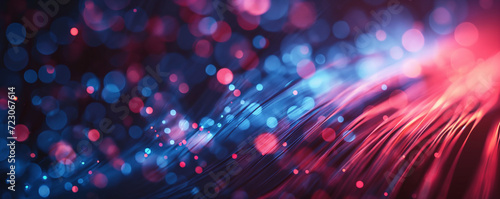 Close-up of optic fibers with dynamic blue and red light bokeh in the background