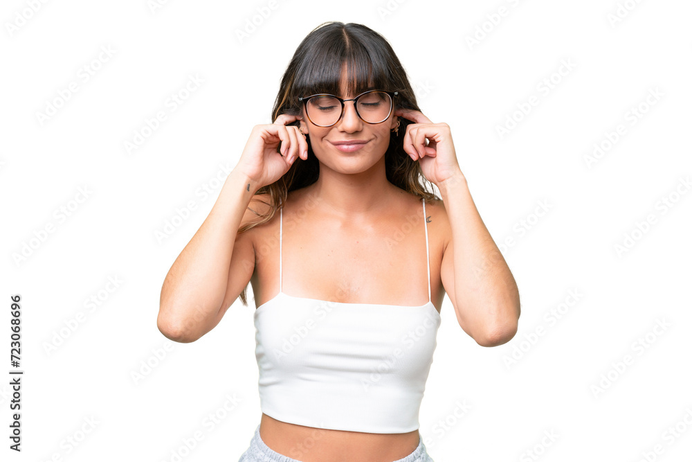 Young caucasian woman over isolated background frustrated and covering ears Young caucasian woman over isolated background frustrated and covering ears