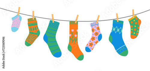 Cotton and wool socks on clothesline, socks on rope with clothespins. Cartoon vector hosiery hang side by side on laundry line. Colorful pairs for kids and adults convey warmth, freshness and texture