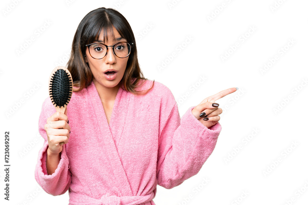 Young woman with hair comb over isolated chroma key background surprised and pointing side Young woman with hair comb over isolated chroma key background surprised and pointing side