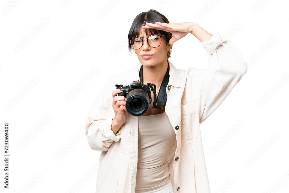 Young photographer caucasian woman over isolated chroma key background looking far away with hand to look something Young photographer caucasian woman over isolated chroma key background looking far away with hand to look something