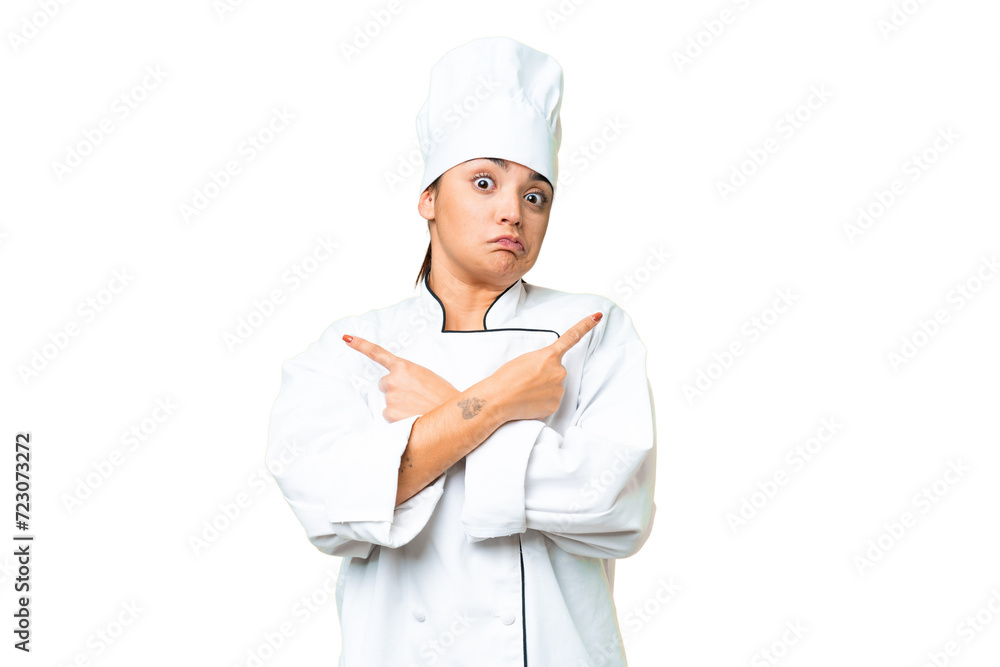 Young woman Chef over isolated chroma key background pointing to the laterals having doubts Young woman Chef over isolated chroma key background pointing to the laterals having doubts