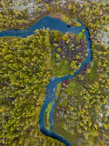 Question mark shaped river course and colorful forest in autumn