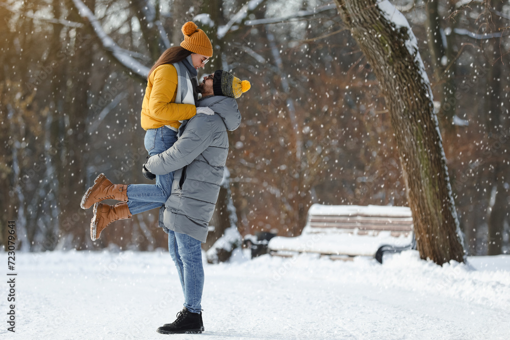 Beautiful happy couple outdoors on winter day. Space for text