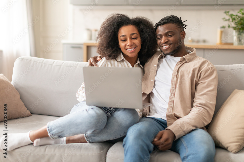 Young Black Spouses Using Laptop Together Browsing Internet At Home Young Black Spouses Using Laptop Together Browsing Internet At Home