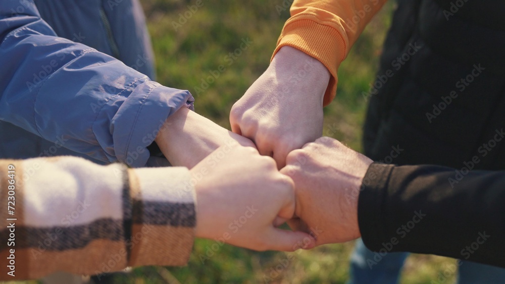 close-up fists a join together team. business team teamwork concept. close-up hands fists together group of people. team of young tourists fists together success lifestyle business concept