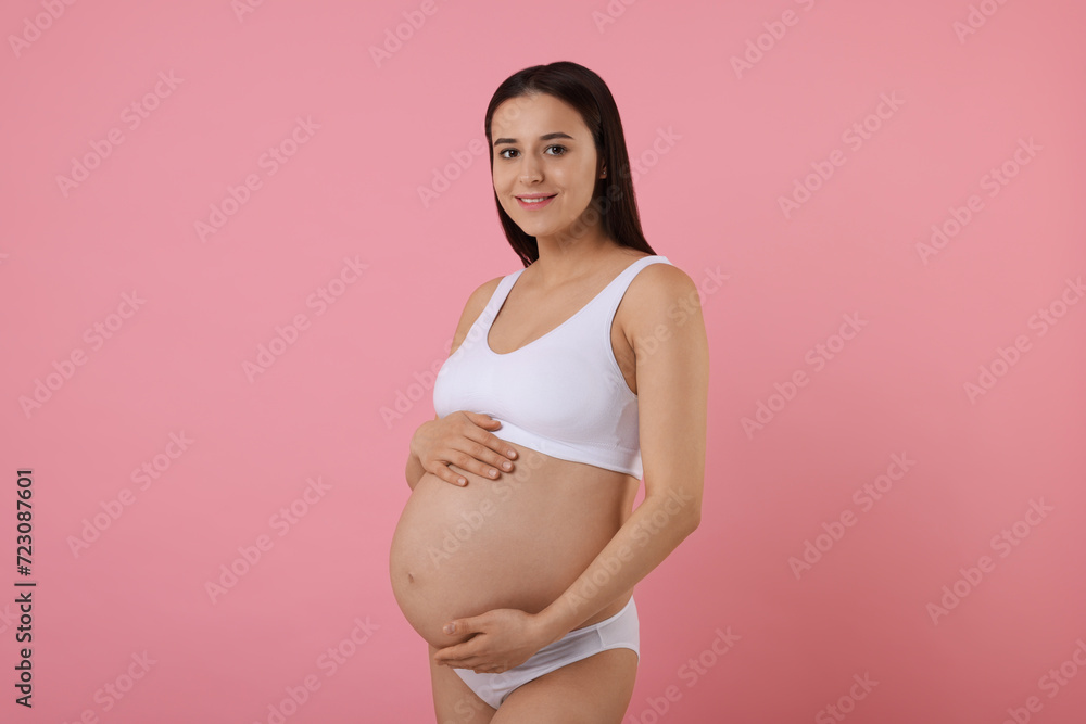 Beautiful pregnant woman in stylish comfortable underwear on pink background Beautiful pregnant woman in stylish comfortable underwear on pink background