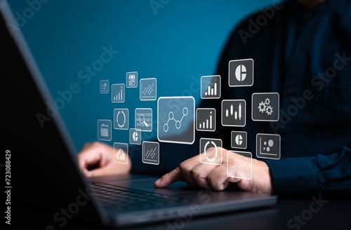 Analyst works on laptop computer to calculate KPI metrics reports with database connected. Data management and business analytics, corporate strategy for finance, sales, operations, and marketing.