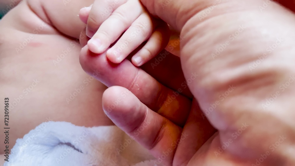 Baby is holding daddy hand. happy family child dream concept. close-up of a hand with a baby. close-up of father hand with baby. Close-up of newborn hand on lifestyle dad Baby is holding daddy hand. happy family child dream concept. close-up of a hand with a baby. close-up of father hand with baby. Close-up of newborn hand on lifestyle dad