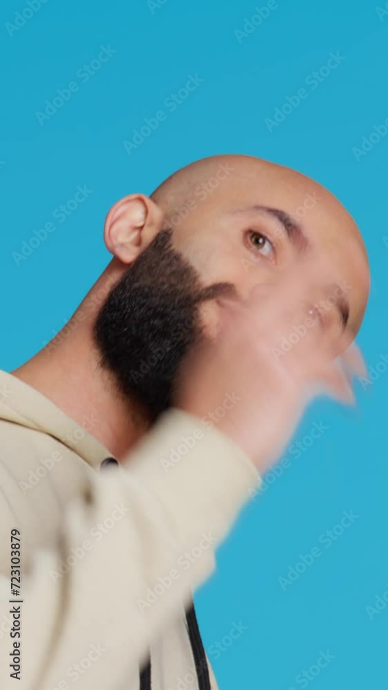 Vertical Video Middle eastern guy asking people to come over, posing over studio background. Arab person invites someone to join him, welcome to come closer on camera, casual invitation. Camera 2 Vertical Video Middle eastern guy asking people to come over, posing over studio background. Arab person invites someone to join him, welcome to come closer on camera, casual invitation. Camera 2