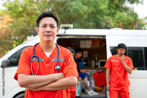 portrait professional asian paramedic proudly standing crossed arms beside ambulance,concept of emergency medical service worker, rescue ambulance at work outside. photo