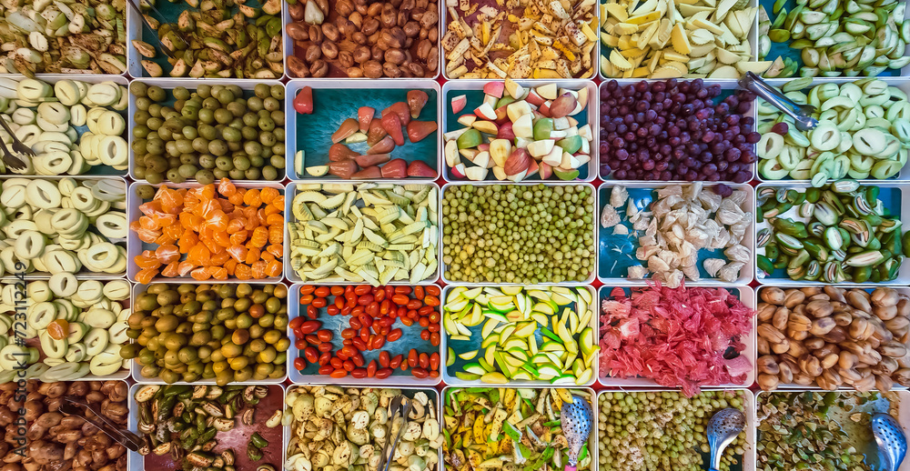 Top view of assorted fruits and pickled fruits on trays for sale in street market, healthy food concept Include high vitamin fruits, fresh fruits, Thai fruits, Street food.Variety fruits as background Top view of assorted fruits and pickled fruits on trays for sale in street market, healthy food concept Include high vitamin fruits, fresh fruits, Thai fruits, Street food.Variety fruits as background