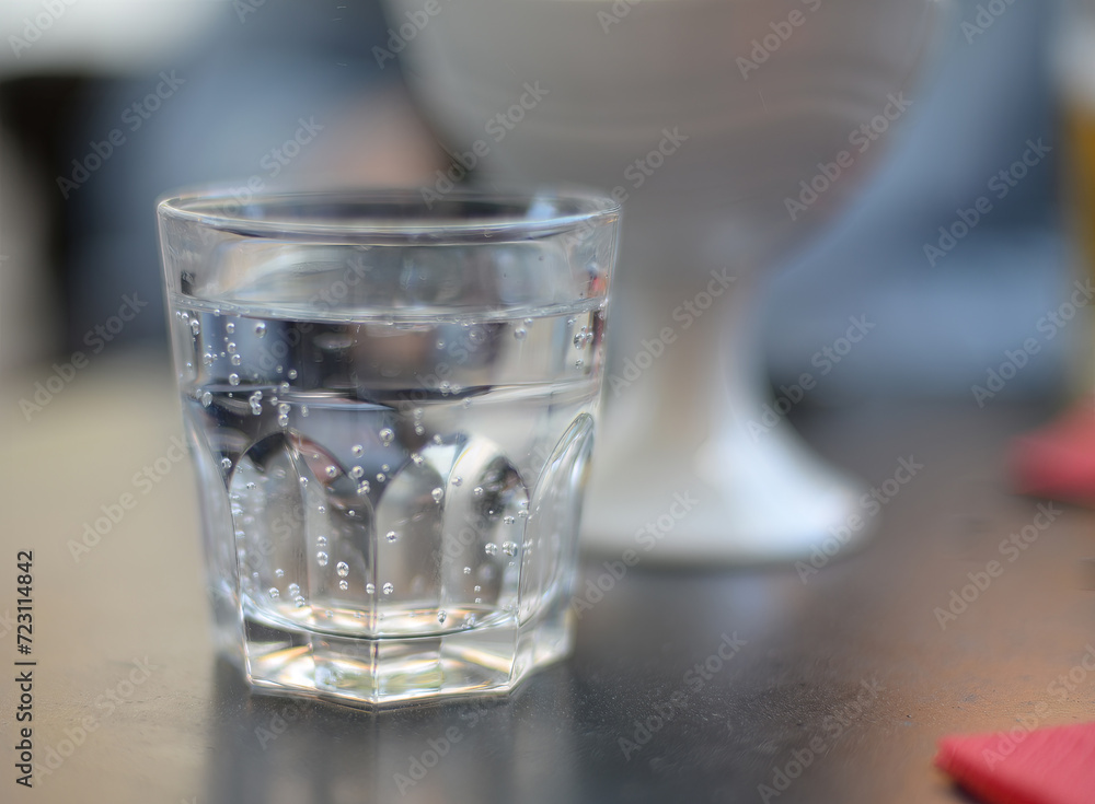 Generic glass filled with sparkling mineral water. Selective focus