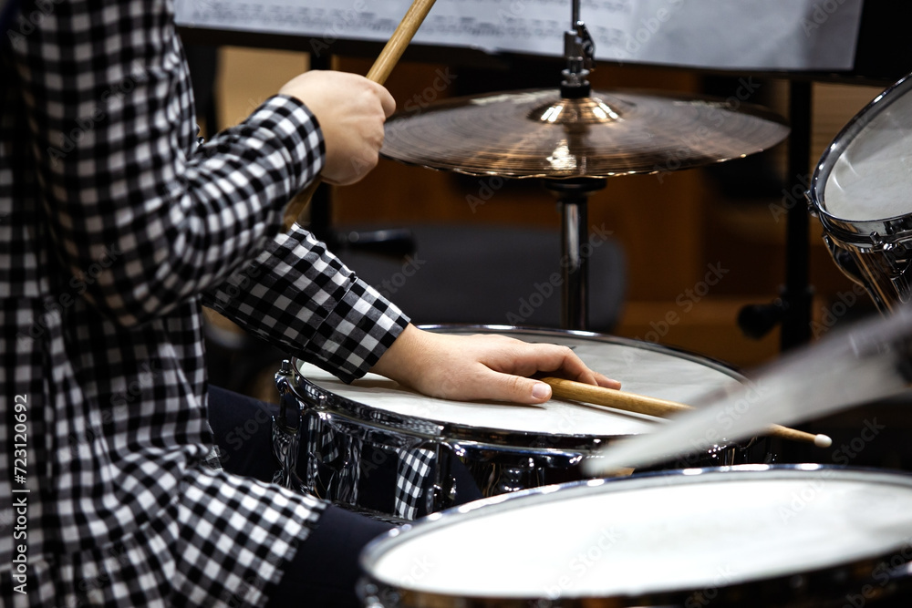 Hands of a girl playing a drum set Hands of a girl playing a drum set