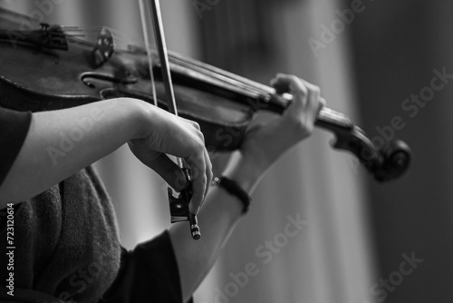 Hands of a woman playing the violin in black and white