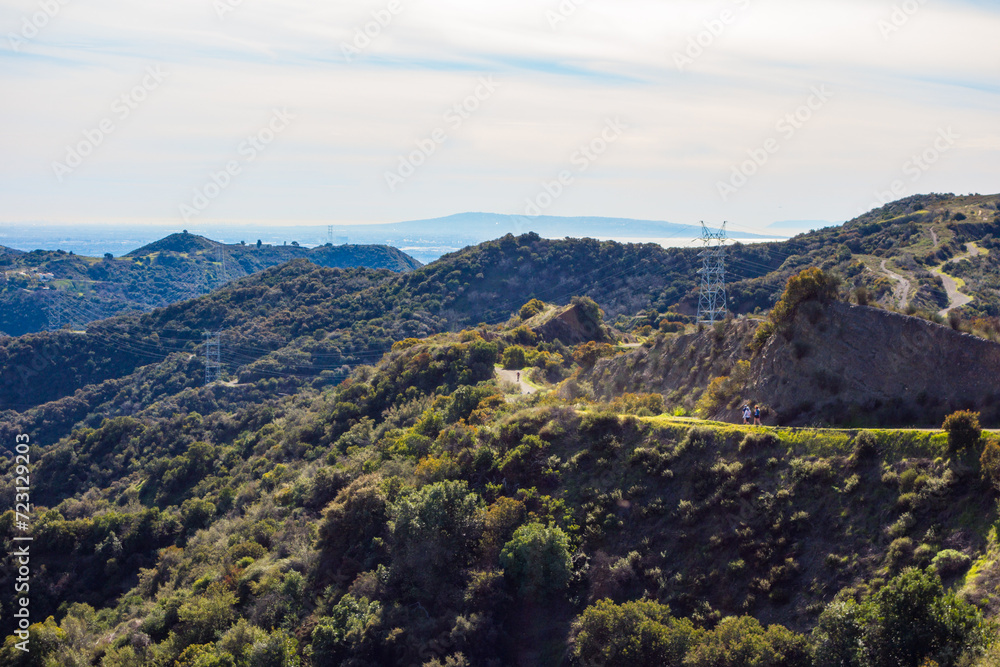 Views of the winding Westridge trail coming up the Santa Monica Mountains with the pacific ocean in the background.