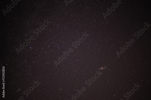 Meteor shower during perseid curent. Andromeda galaxy in the night sky photo