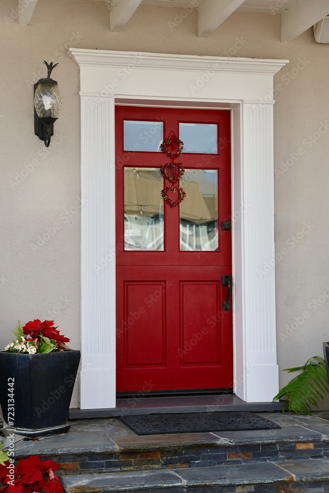 Fototapeta premium Bright red front door with white wood moulding