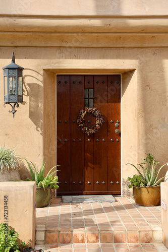 Heavy wood front door to an elegant villa photo
