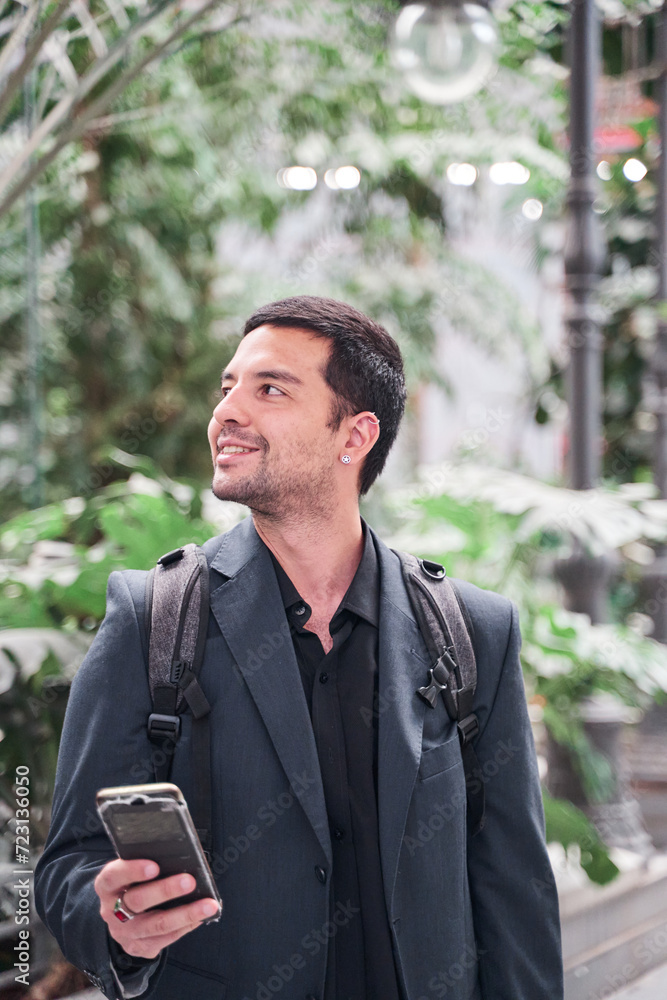 close-up vertical portrait of a latin man holding a smart phone smiling. close-up vertical portrait of a latin man holding a smart phone smiling.