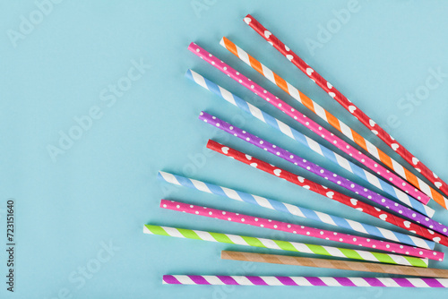 Different colordul paper straws on blue background photo