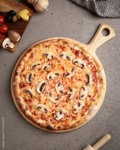 Delicious pizza with mushrooms, mozzarella and tomato sauce.
