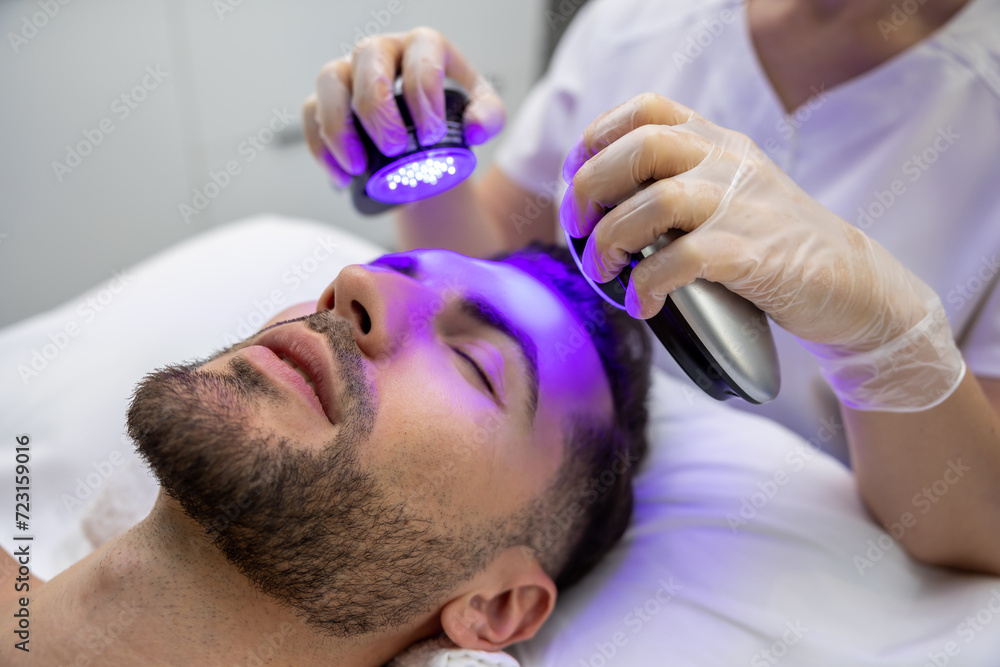 Man lying on a couch and having a phototherapy session Man lying on a couch and having a phototherapy session