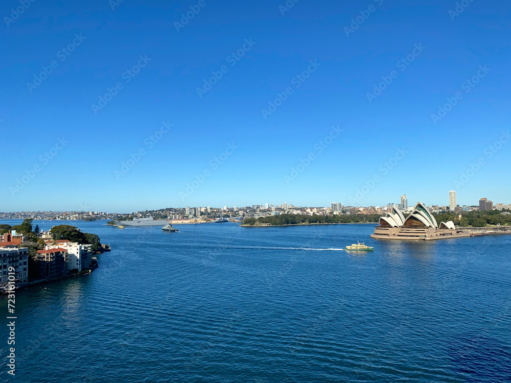 View of Sydney bay, Australia. Panorama of the city's coastline from the ocean. Sydney Opera House and buildings on the island's coastline.