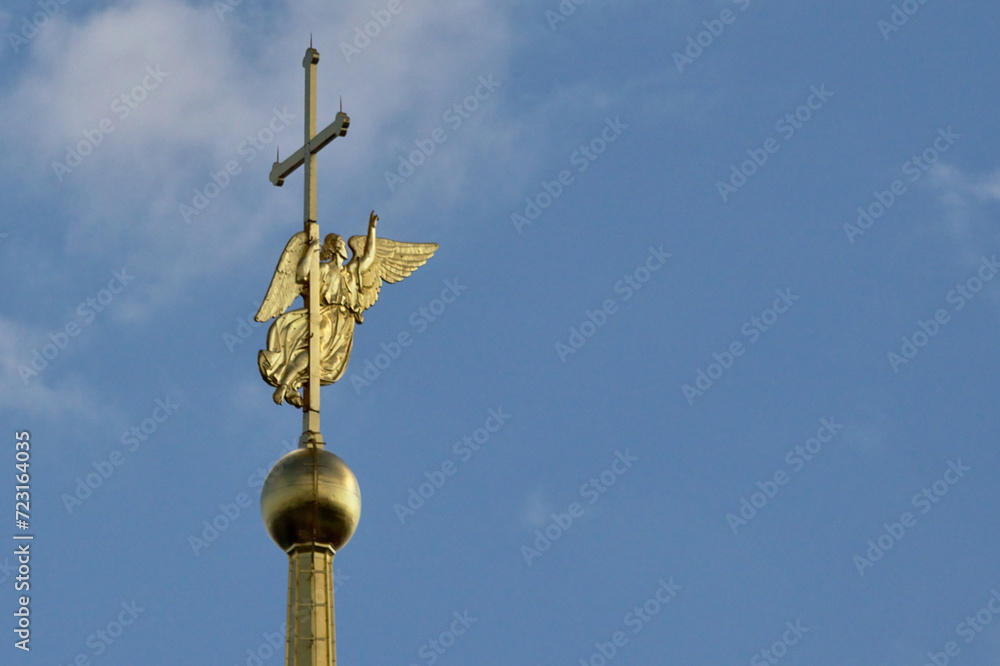 A close-up view of the golden spire of the Peter and Paul Cathedral in the city of St. Petersburg.