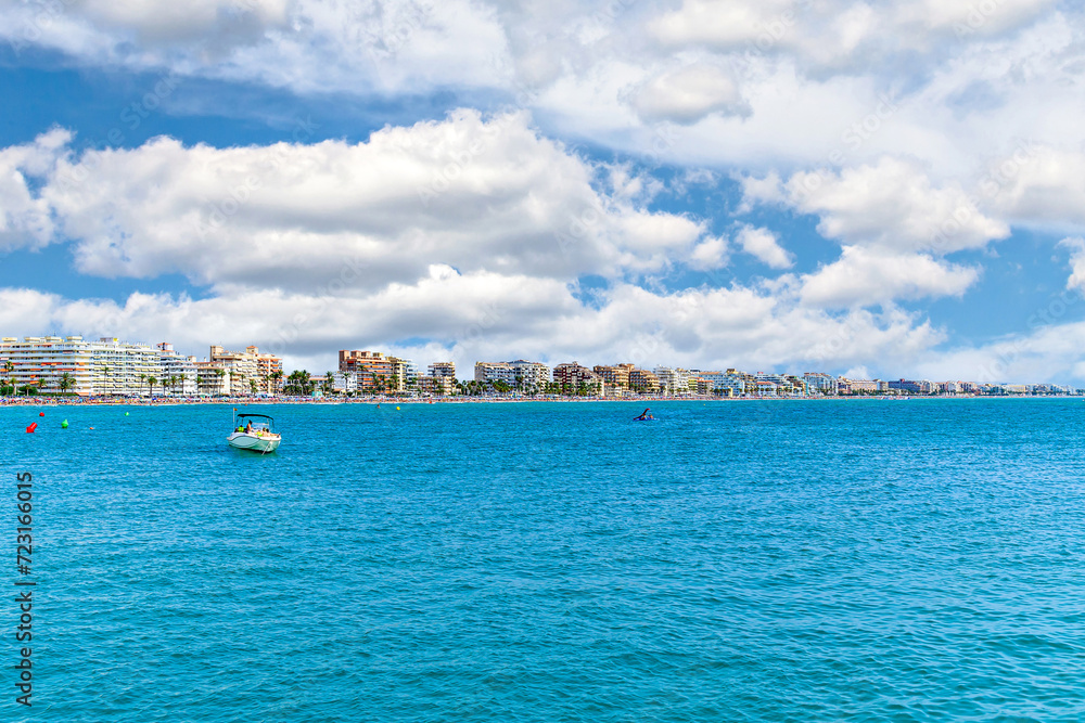 Views of Peñiscola beach from its famous castle on a sunny day with white clouds. Castellon, Valencian Community, Spain