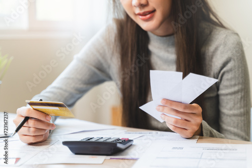 Financial owe, hand of asian woman sitting, holding credit card, stressed by calculate expense from invoice or bill, no money to pay, mortgage or loan
