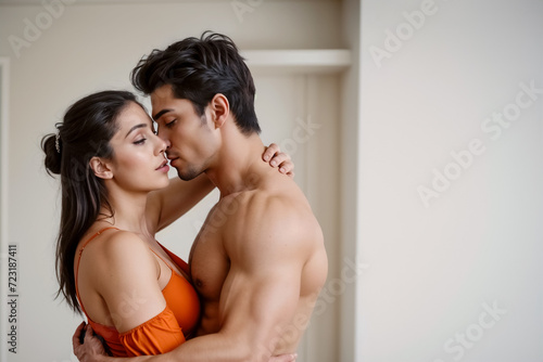Fiamme dell'Amore- Coppia Giovane e Attraente in un Abbraccio Sensuale photo